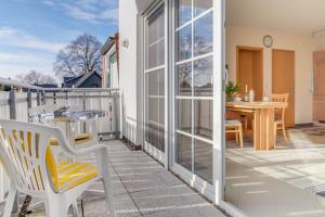 a patio with a table and chairs on a balcony at Friedenstraße 21 Whg 5 in Zingst
