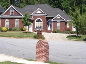 a house with a brick pillar in front of a street at Serenity Place in Decatur