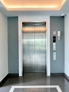 a elevator in a building with a shiny metal door at Sabai Residence @Bangyai in Nonthaburi