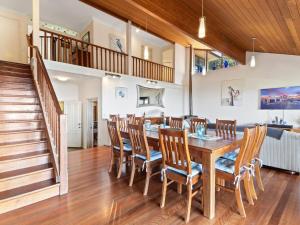 a dining room with a wooden table and chairs at Belle Vue in Point Lookout