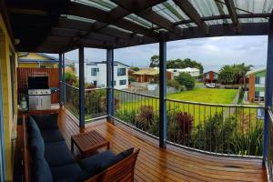 a balcony with a view of a yard at Beachside Bliss with Secure yard l Pet Friendly in Apollo Bay