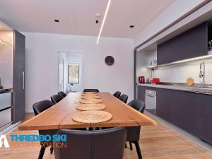 a kitchen with a long wooden table and chairs at Cedar Creek 3 in Thredbo