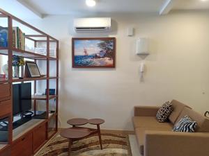 a living room with a couch and a tv at Timurbay Lavender Homestay in Kampung Sungai Karang