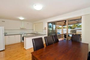 a kitchen and dining room with a table and chairs at Intrigue FREE WI-FI in Apollo Bay