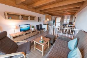 a living room with a couch and a tv at Fewo Nachbaur Typ A1 in Oberjoch