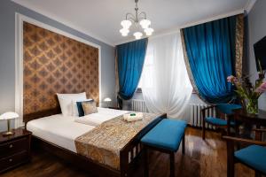 Łóżko lub łóżka w pokoju w obiekcie Baron Boutique Hotel