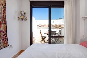 a bedroom with a bed and a view of a patio at Ático Heaven in Earth in Zahara in Zahara de los Atunes