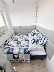 a small bedroom with two beds in it at Warszawska 15 Apartament in Gdynia