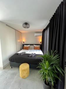 a bedroom with a large bed and a large window at New Amsterdam Harlem Hotel in Haarlem