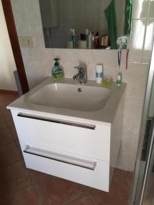 a white sink in a bathroom with a mirror at da Susanna in Perticara
