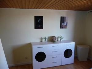 a room with a white cabinet with black circles on it at Wohnung in der "Alten Post" in Hohenhameln