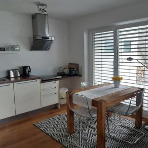 a kitchen with a wooden table and a dining room at Ferienwohnung im Weinbergweg in Ravensburg