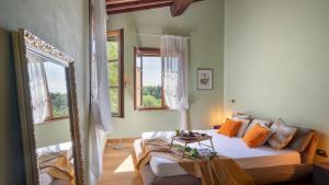 a bedroom with a bed and two windows at La Villa nell'Isola Verde 12, Emma Villas in Casciana Terme