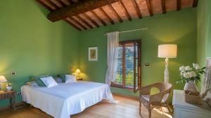 a green bedroom with a bed and a window at La Villa nell'Isola Verde 12, Emma Villas in Casciana Terme +38 photos
