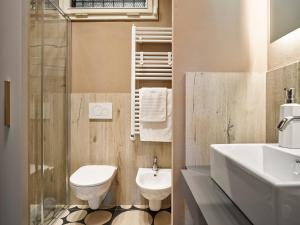 a bathroom with a toilet and a sink and a shower at Cascina Galileo in Florence