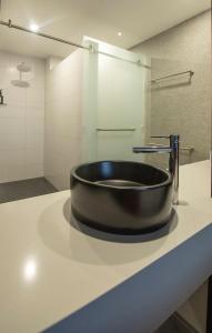 a bathroom with a black sink on a counter at Bridgeport Hotel in Murray Bridge