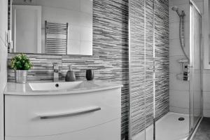 a white bathroom with a sink and a shower at Apartamento El Coso in Logroño