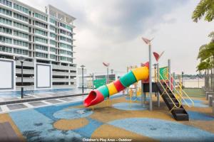 a playground with a slide in front of a building at Baojuwu@2 Bedrooms Akademik Suites Austin Height in Johor Bahru