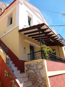 a house with stairs and a balcony at Marina Studios in Symi