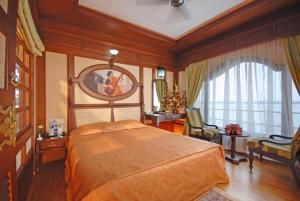 a bedroom with a large bed and a large window at Sterling Houseboats Lake Palace, Alleppey in Alleppey