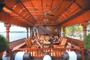 a group of people sitting on the deck of a boat at Sterling Houseboats Lake Palace, Alleppey in Alleppey