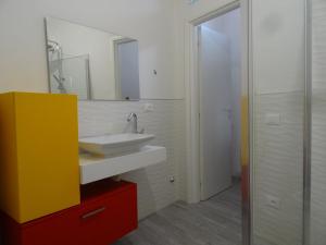 a bathroom with a sink and a mirror at alcastello - casa campanile in Isola del Giglio