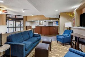 a living room with a blue couch and two chairs at Comfort Inn Brownsville I-40 in Brownsville