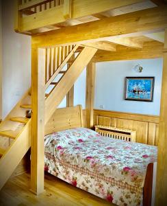 a bedroom with a bed and a wooden staircase at Pirin Golf Hotel Private Apartments Апартаменти Планински Изгрев в Пирин Голф in Razlog +11 photos