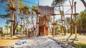 a playground with a wooden structure in a park at Azul Beach Resort Montenegro by Karisma - All Inclusive in Ulcinj