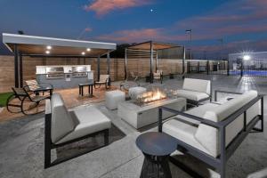 a patio with white furniture and a fire pit at Staybridge Suites Waco South - Woodway, an IHG Hotel in Woodway