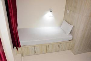 Cette chambre dispose d'un banc avec un oreiller. dans l'établissement BKC Dormitory Bandra East, à Mumbai