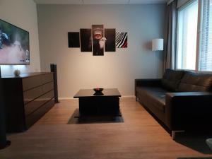 a living room with a couch and a table at J House in Jyväskylä