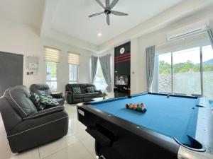 a living room with a pool table in it at Spacious Home with Private Swimming Pool in Langkawi by Zervin in Kuah