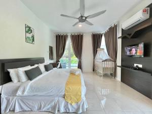 a bedroom with a bed and a ceiling fan at Spacious Home with Private Swimming Pool in Langkawi by Zervin in Kuah