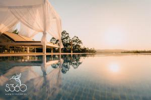 a view of a pool of water with a building at Casa Albarari Boutique Double Rooms with access to shared Infinity Pool in Sanxenxo