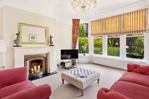 a living room with a couch and a fireplace at Central Harrogate townhouse apartment with parking in Harrogate