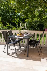 a black dining table and chairs on a patio at City Apartments in Trebinje