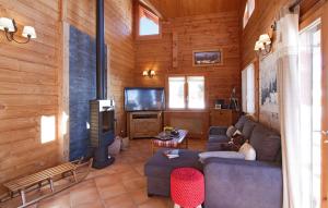 a woman sitting on a couch in a living room at Odalys Chalet Le Panorama in Les Deux Alpes