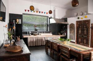 a kitchen with a table with chairs and a sink at Seven Maze Charming House in Bari