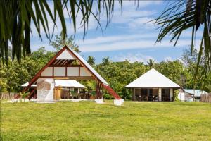 a house in the middle of a field at Bird Island Seychelles - Private Island Villas in Bird Island