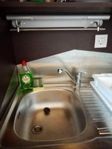 a kitchen sink with a soap bottle next to it at Santo Spiti sou 3 in Fira +20 photos