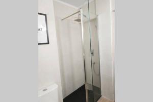 a glass shower in a bathroom with a toilet at La Casa de Kiko. in Santoña +17 photos