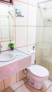 a bathroom with a toilet and a sink at Hotel Portal dos Ventos in Parnaíba +13 photos