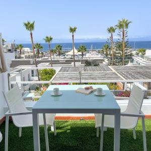 a table and chairs with a view of the ocean at Flamingo Beach Mate in Adeje