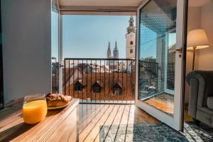 a glass of orange juice and a plate of food on a table at Lux Apartments in Zagreb