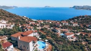 an aerial view of a village on a hill next to the water at Hill House Adult Only in Kaş