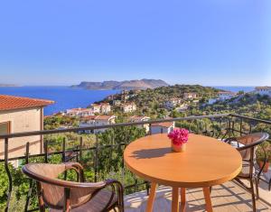 a table on a balcony with a view of the ocean at Hill House Adult Only in Kaş