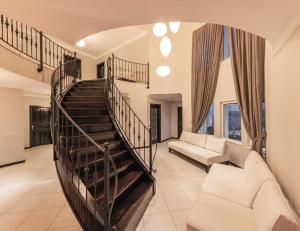 a spiral staircase in a living room with a couch at Hill House Adult Only in Kaş