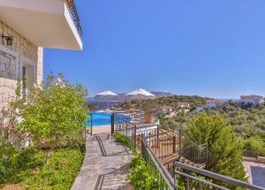 a view from the balcony of a house with a swimming pool at Hill House Adult Only in Kaş