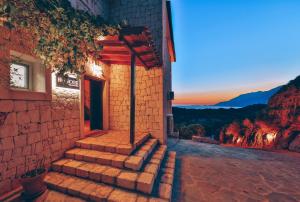 a set of stairs outside of a building with the sunset at Hill House Adult Only in Kaş